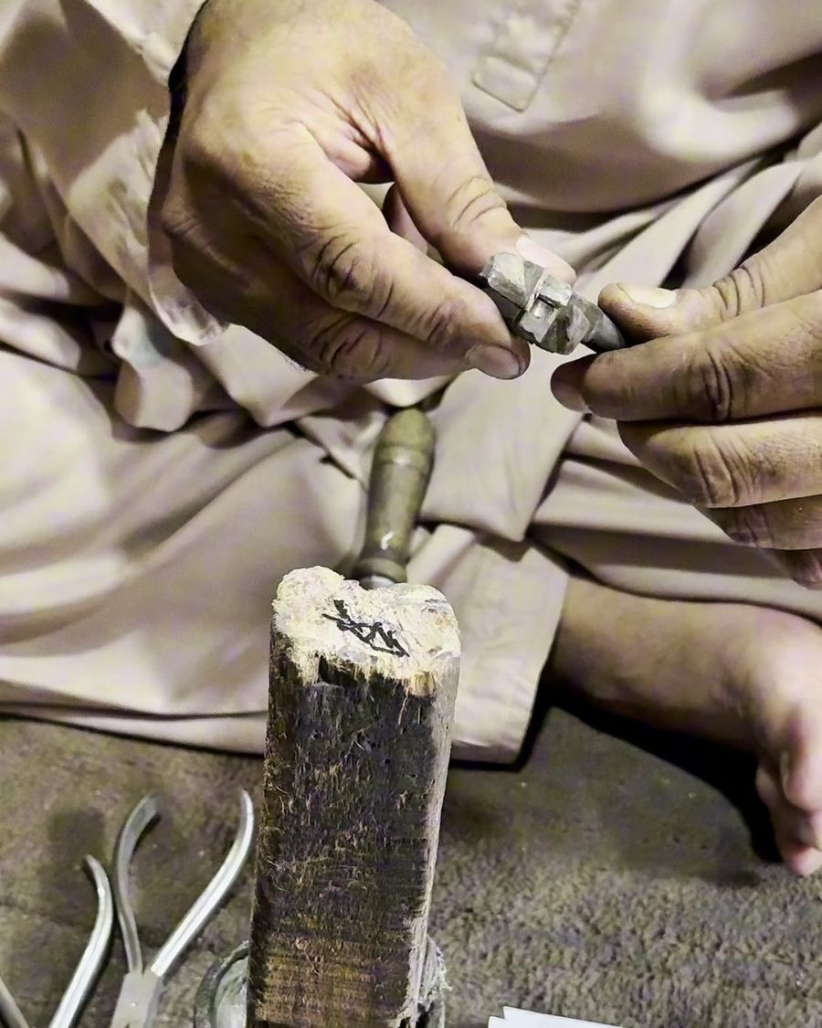 A Mubarra Instrumed craftsman filing the joint of an orthodontic plier by hand in the Sialkot workshop